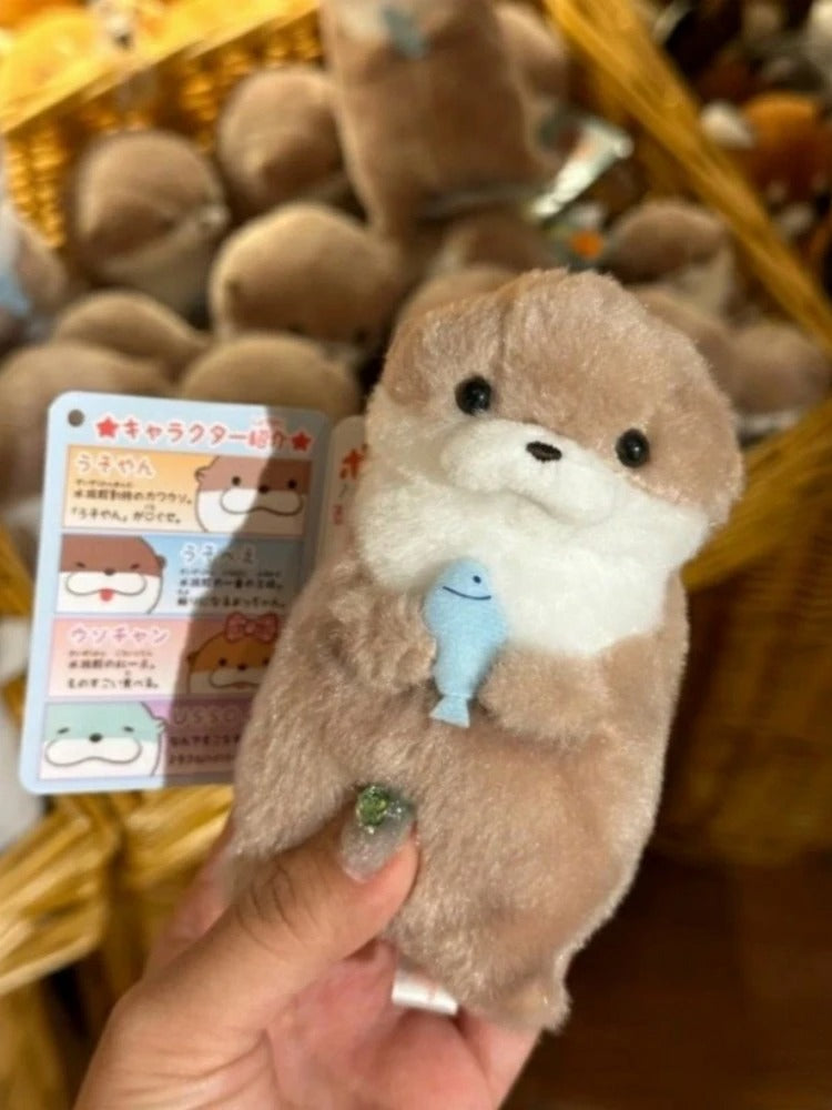 Otter Holding Fish Keychain